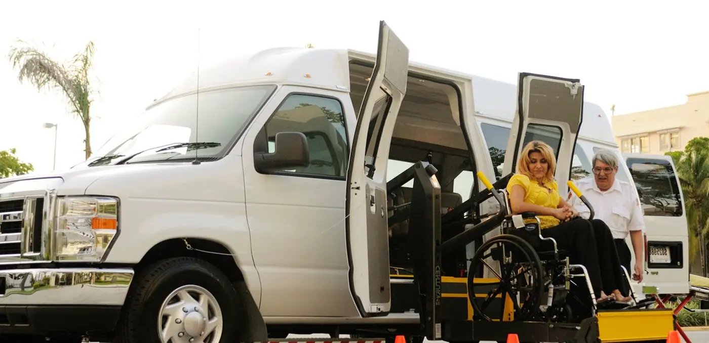 Rider boarding a lift-equipped One Premier Transit van in a wheelchair